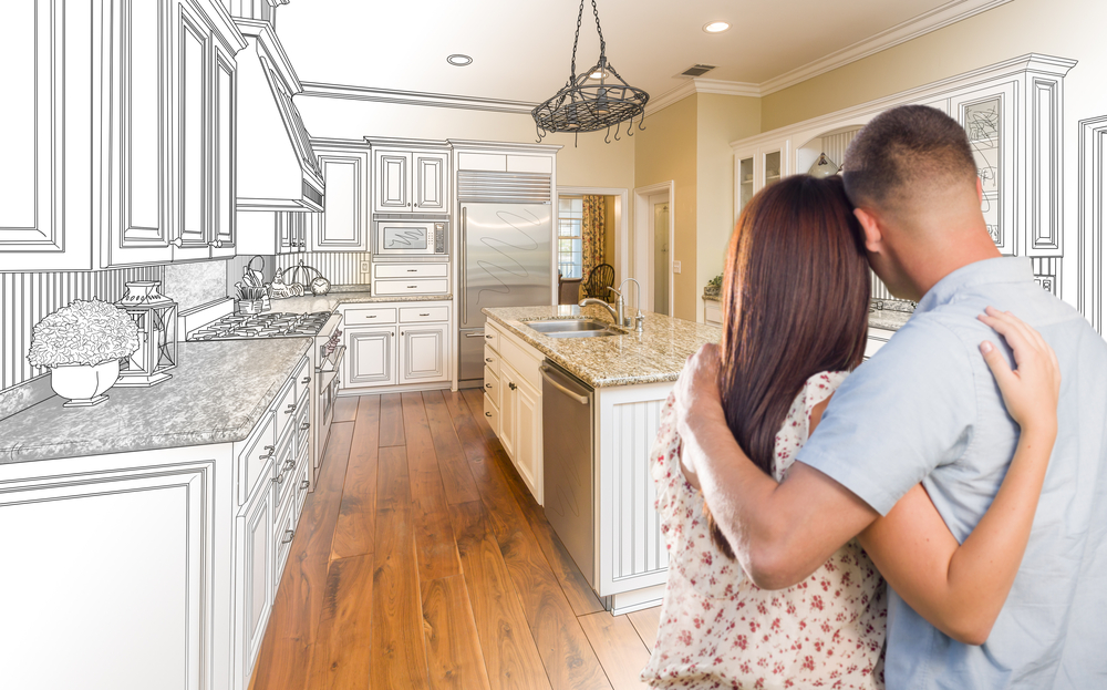 Young,military,couple,looking,inside,custom,kitchen,and,design,drawing